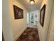 Inviting hallway featuring neutral walls, modern light fixture, and decorative art at 1433 Kingston Ave, Orlando, FL 32807