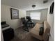 Home office setup featuring a desk, office chair, computer, and futon at 1433 Kingston Ave, Orlando, FL 32807
