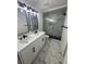 Bathroom featuring modern vanity, decorative tile floor, and glass shower with black hardware at 1538 Brookebridge Dr, Orlando, FL 32825