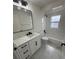 Updated bathroom featuring modern vanity, marble countertop, and stylish fixtures at 1538 Brookebridge Dr, Orlando, FL 32825