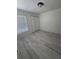 A simple bedroom with light-colored laminate wood flooring and neutral colored walls at 1538 Brookebridge Dr, Orlando, FL 32825