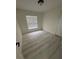 A simple bedroom with light-colored laminate wood flooring and neutral colored walls at 1538 Brookebridge Dr, Orlando, FL 32825