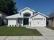 Charming single-story home with a well-manicured lawn and a freshly painted, modern exterior at 1538 Brookebridge Dr, Orlando, FL 32825