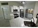 Bright kitchen featuring modern appliances, quartz countertops, and a cozy breakfast bar at 1538 Brookebridge Dr, Orlando, FL 32825