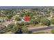 An aerial view of the beautiful home in its community, with mature landscaping and nearby road at 1551 Sherbrook Dr, Clermont, FL 34711