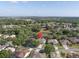 An aerial view of this cozy home within its neighborhood, surrounded by mature trees at 1551 Sherbrook Dr, Clermont, FL 34711