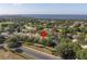 Stunning aerial view of home within a lush community, near the water, golf course and beautiful landscaping at 1551 Sherbrook Dr, Clermont, FL 34711