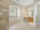 Bright bathroom boasts a glass-enclosed shower, separate tub, and vanity with ample counter space at 1551 Sherbrook Dr, Clermont, FL 34711