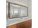 Bathroom featuring granite counter, undermount sink, framed mirror with lighting, and vanity at 1551 Sherbrook Dr, Clermont, FL 34711