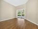 Large bedroom with wood floors and sliding glass doors leading to the lanai at 1551 Sherbrook Dr, Clermont, FL 34711