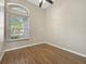 Bright bedroom features wood floors, a ceiling fan and a large window at 1551 Sherbrook Dr, Clermont, FL 34711