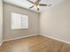 Bedroom with ceiling fan, wood floors, and window with mini blinds at 1551 Sherbrook Dr, Clermont, FL 34711