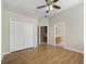 Bedroom featuring closet and wood floors, with a bathroom visible through the open doorway at 1551 Sherbrook Dr, Clermont, FL 34711