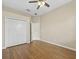 Bedroom featuring closet and wood floors, with a bathroom visible through the open doorway at 1551 Sherbrook Dr, Clermont, FL 34711