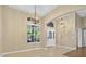 Inviting foyer with decorative lighting, high ceilings, and elegant front door at 1551 Sherbrook Dr, Clermont, FL 34711
