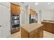Kitchen featuring stainless steel double ovens and center island at 1551 Sherbrook Dr, Clermont, FL 34711
