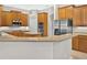 Spacious kitchen featuring wood cabinetry, stainless steel appliances, and a center island at 1551 Sherbrook Dr, Clermont, FL 34711