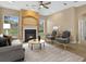 Elegant living room with a cozy fireplace, sophisticated furnishings, and ample natural light at 1551 Sherbrook Dr, Clermont, FL 34711