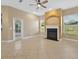 Open living room area featuring a fireplace, a ceiling fan, and views to the backyard at 1551 Sherbrook Dr, Clermont, FL 34711
