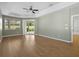 Spacious main bedroom features wood floors, a tray ceiling, and a sliding glass door to the lanai at 1551 Sherbrook Dr, Clermont, FL 34711
