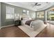 Main bedroom features a tray ceiling, wood floors, and sliding doors to the lanai at 1551 Sherbrook Dr, Clermont, FL 34711