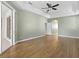 Large main bedroom with wood floors, a ceiling fan, and sliding glass doors to the lanai at 1551 Sherbrook Dr, Clermont, FL 34711