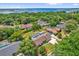 Aerial view of a home in a lush neighborhood, near a lake and with a pool at 1558 Regal Oak Dr, Kissimmee, FL 34744