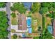 Aerial view of property featuring screened pool, fenced yard and mature trees at 1558 Regal Oak Dr, Kissimmee, FL 34744