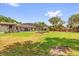 Large backyard with a screened pool enclosure, raised garden beds, and a privacy fence at 1558 Regal Oak Dr, Kissimmee, FL 34744