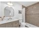 Elegant bathroom showcasing a shower with tiled walls, a gold rainfall shower head, and a marble countertop at 1558 Regal Oak Dr, Kissimmee, FL 34744