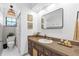 Classic bathroom with patterned shower curtain, framed artwork, and a granite-look countertop at 1558 Regal Oak Dr, Kissimmee, FL 34744