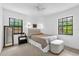 Sunny bedroom with natural light, neutral carpeting, and an accent mirror in the corner at 1558 Regal Oak Dr, Kissimmee, FL 34744