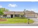 Charming single-story home features a well-manicured lawn and beautiful landscaping at 1558 Regal Oak Dr, Kissimmee, FL 34744