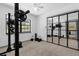 Home gym featuring mirrored walls, ample natural light, and state-of-the-art exercise equipment at 1558 Regal Oak Dr, Kissimmee, FL 34744