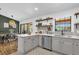 Well-equipped kitchen with stainless steel appliances, stylish backsplash, and a view to the dining area at 1558 Regal Oak Dr, Kissimmee, FL 34744
