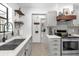 Bright kitchen featuring gray cabinets, modern appliances, and white countertops with backsplash at 1558 Regal Oak Dr, Kissimmee, FL 34744