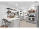 Stylish kitchen featuring an island with breakfast bar, stainless steel appliances, and herringbone flooring at 1558 Regal Oak Dr, Kissimmee, FL 34744