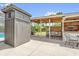 The spacious outdoor patio with custom potting shed and ample space for seating and relaxation at 1558 Regal Oak Dr, Kissimmee, FL 34744