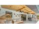 Covered pool area with brick walls, wood ceilings, outdoor seating, and an outdoor grill at 1558 Regal Oak Dr, Kissimmee, FL 34744