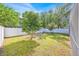 A serene backyard featuring lush greenery and a white fence offers a private and peaceful outdoor space at 16844 Rising Star Dr, Clermont, FL 34714