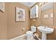 Cozy half bathroom featuring neutral walls, ceramic tile floors and pedestal sink at 16844 Rising Star Dr, Clermont, FL 34714