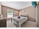 Inviting bedroom featuring a queen-sized bed, natural light, and contemporary decor at 16844 Rising Star Dr, Clermont, FL 34714