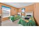 Bedroom featuring two twin beds with colorful bedspreads and cartoon accents at 16844 Rising Star Dr, Clermont, FL 34714