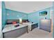 Bedroom featuring two beds, blue walls with flower decor, and a TV on the wall at 16844 Rising Star Dr, Clermont, FL 34714