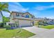Well-maintained two-story home featuring a two-car garage, landscaped front yard, and inviting curb appeal at 16844 Rising Star Dr, Clermont, FL 34714
