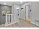 Hallway with wood floors and neutral walls leading to bedrooms, with decor at 16844 Rising Star Dr, Clermont, FL 34714