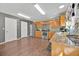 Well-lit kitchen with stainless steel appliances, wood cabinets, and granite countertops at 16844 Rising Star Dr, Clermont, FL 34714