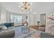Bright living room with stylish decor, hardwood floors, and a view of the entrance at 16844 Rising Star Dr, Clermont, FL 34714