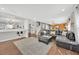 Spacious open-concept living area with modern furnishings and seamless flow to other spaces at 16844 Rising Star Dr, Clermont, FL 34714