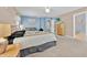 Primary bedroom with blue accent walls and a king-sized bed, dresser, and a ensuite bathroom at 16844 Rising Star Dr, Clermont, FL 34714